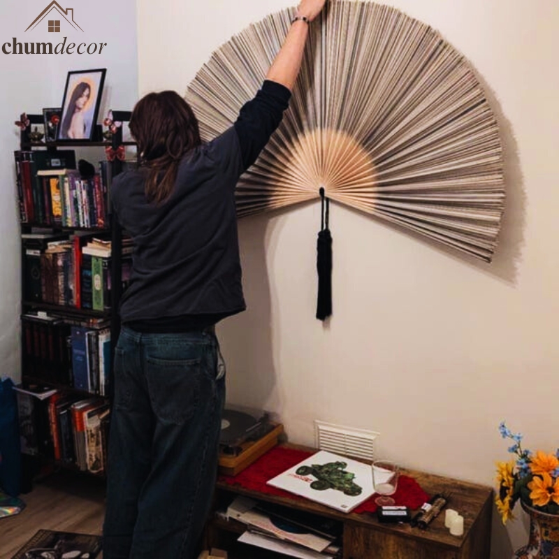 Hanging a bamboo fan wall and adjusting folds for symmetry